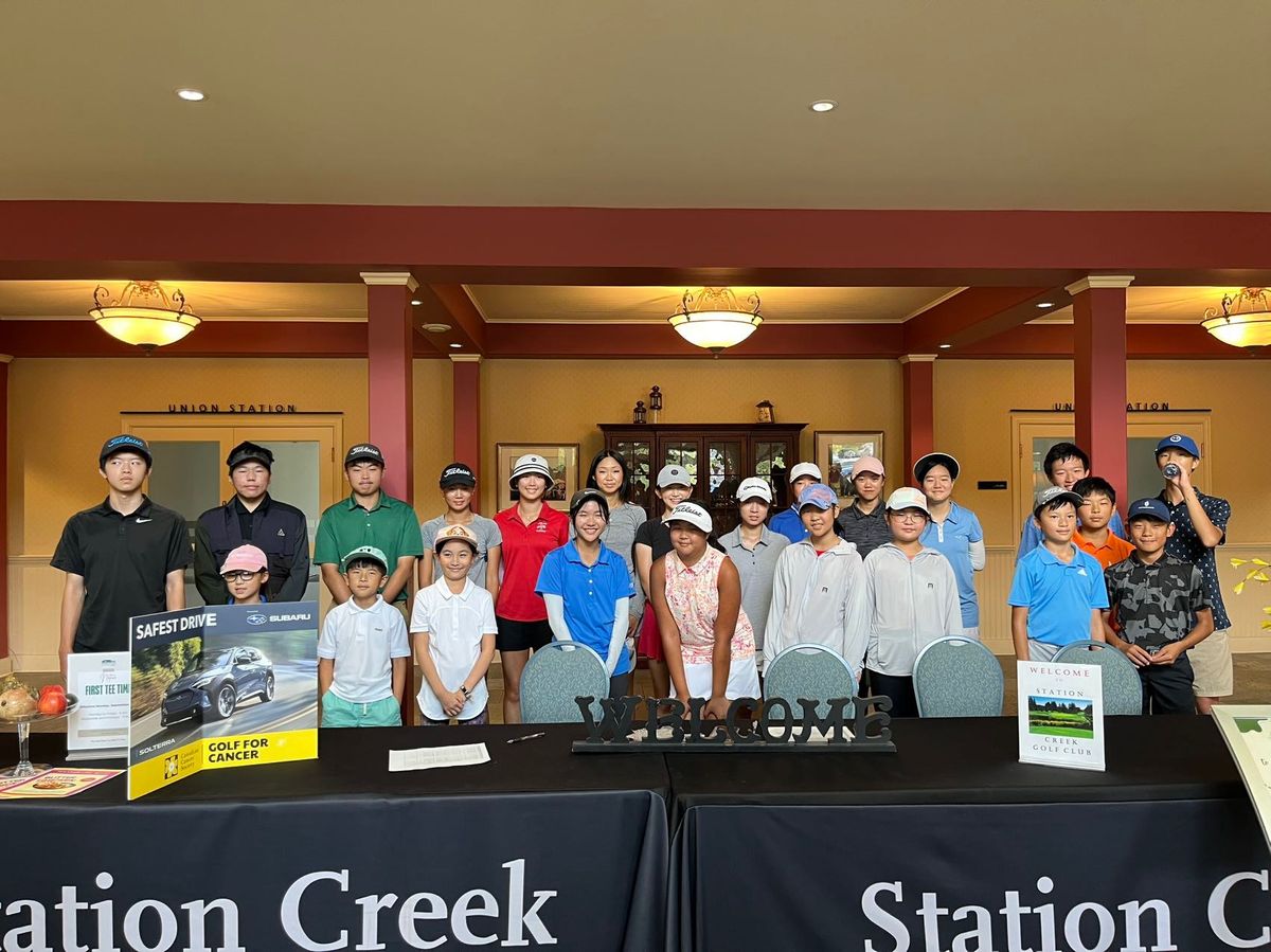 TTGA Junior Tournament participants standing together behind the welcome table in 2024